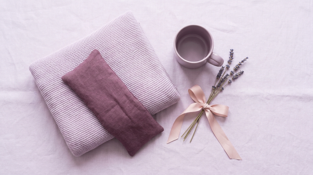 Bright gift flat-lay of comfort items in plum and lilac