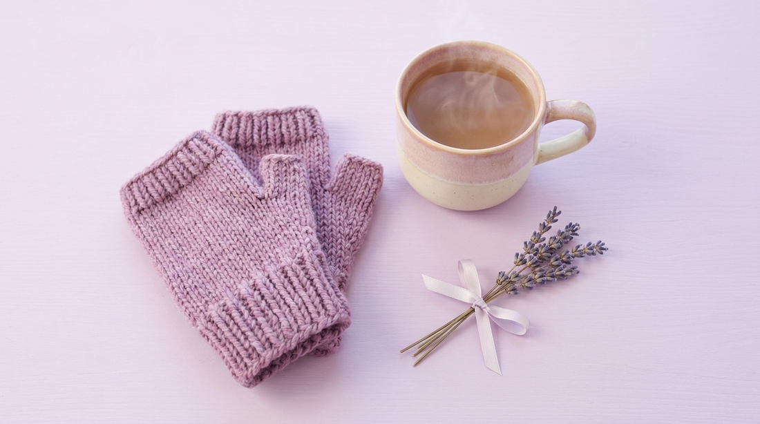 Soft lilac fingerless gloves, a warm mug and lavender on a bright surface
